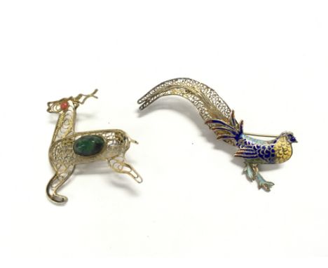 Two silver filigree brooches the deer is set with polish stones and the others is an vintage Art Deco style enamel peacock br