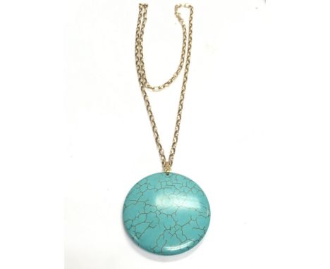 A 9ct gold chain and turquoise disc pendant . Chain approximately 4g total weight. 30cm chain length. Postage category A