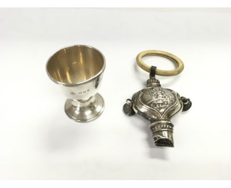 A London hallmarked silver egg cup from circa 1950 weighing 28.81g and a Birmingham hallmarked silver 1926 Rattle 44.25g