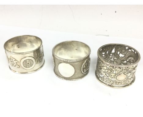 Three Chinese silver napkin rings . Postage category A