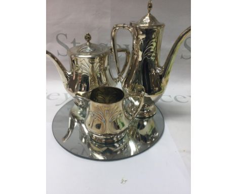 A WMF three piece tea set tea pot hot water pot milk jug having Art nouveau influence on a circle mirror base .