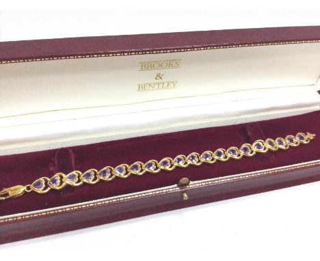 A silver gilt Amethyst heart bracelet. Postage category A