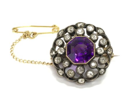 A gold and silver diamond and amethyst set brooch. Diameter approximately 20mm and 6g Postage B