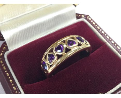 A 14ct gold and amethyst hearts ring. Size T. 4.6g total weight. Postage category A