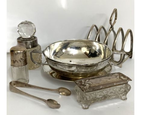 A two handled silver soup bowl and saucer, marks for Birmingham 1921, George Unite. Together with hallmarked silver toast rac