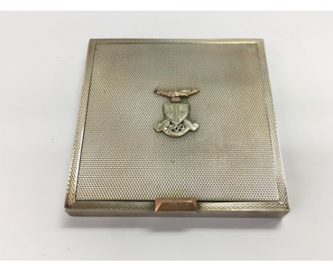 A silver hallmarked compact with a military insignia on the front.