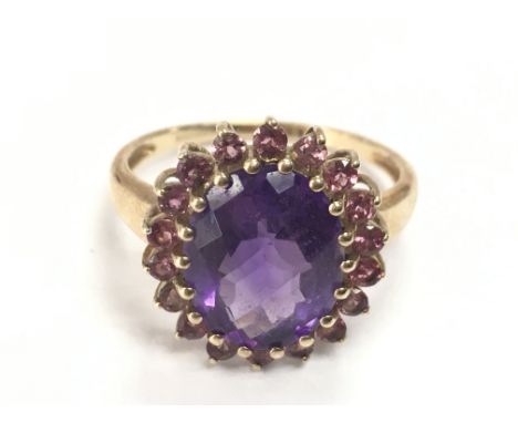 A 9ct gold purple amethyst and rhodolite ring, size R/S. 4g total weight. postage category A