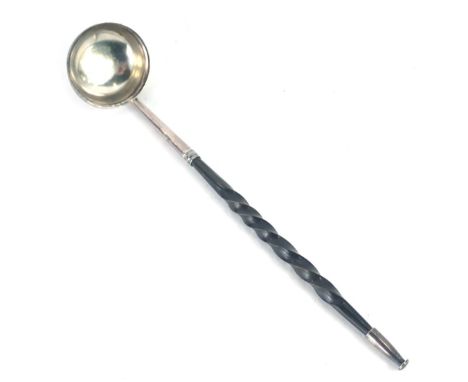 A Georgian toddy ladle, with white metal mounts, on a turned ebony handle, unmarked, 21cm long. 