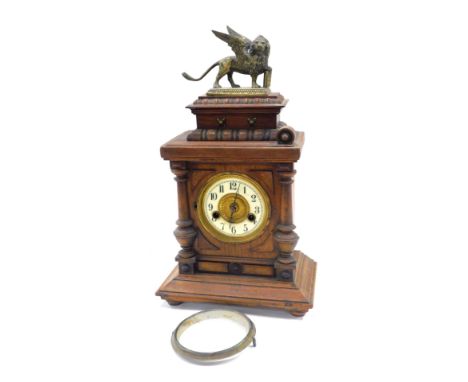 A late 19thC Hamburg Clock Company walnut cased mantel clock, circular brass dial with enamel chapter ring bearing Arabic num