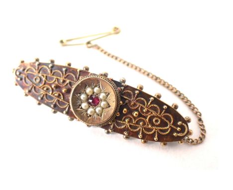 A 15ct gold bar brooch, central circular panel set with seed pearl and ruby, with filigree type decoration on single pin back