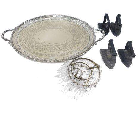 A late Victorian oval engraved two handled tray, with pierced border, four various flat irons, and a basket ceiling light fit