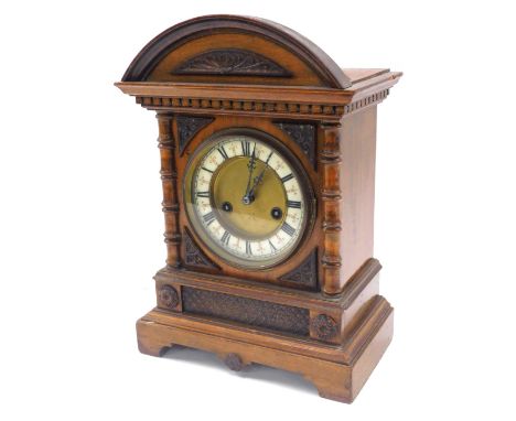 A late 19thC Hamburg Clock Company walnut cased mantel clock, circular brass dial with enamel chapter ring bearing Roman nume