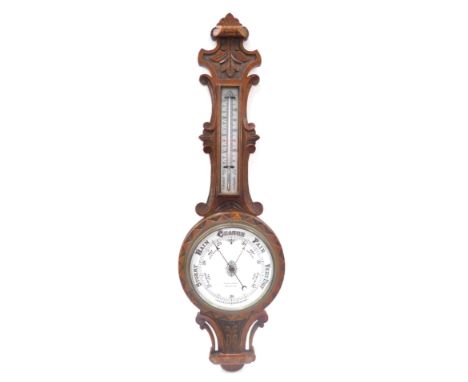 A Victorian oak cased aneroid barometer, by D Mullarky of Bradford, with thermometer, the case with foliate and dog tooth car