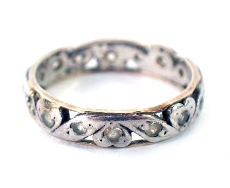 An eternity ring, with two panelled yellow metal outer border, and white gold centre, set with white stones, unmarked, believ