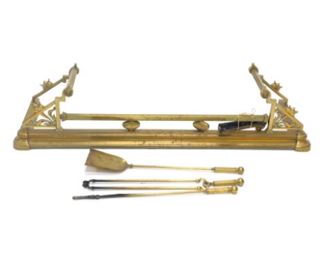 A Victorian Aesthetic movement brass fire fender and fire side tools, 122cm internal width. 
