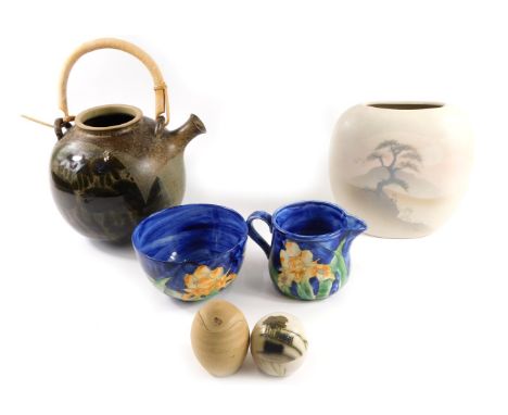 A group of studio pottery, comprising a painted blue bowl stamped Idonia, and matching milk jug, egg cup, brown teapot, and a