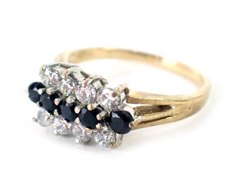 A 9ct gold dress ring, set with imitation diamonds and imitation sapphires, of three row design, ring size H½, 2.1g all in. 