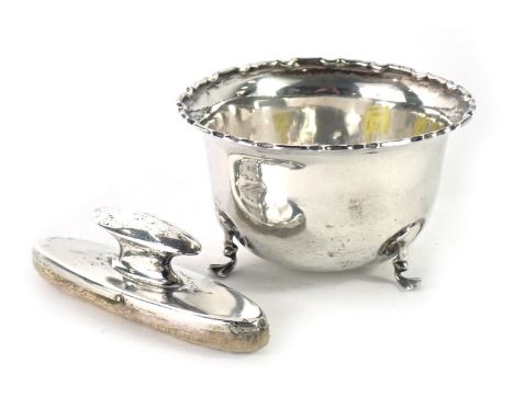 A George V silver sugar bowl, with petalated border, on tripod claw feet, Birmingham 1922, 1.41oz, and a silver topped nail b