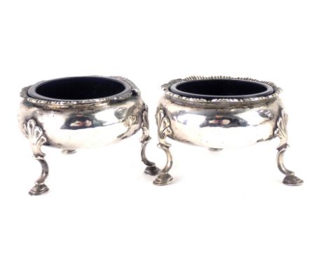 A pair of 18thC silver salts, with petalated border and shell tripod feet, with blue glass liners, from the Earl of Breadalba