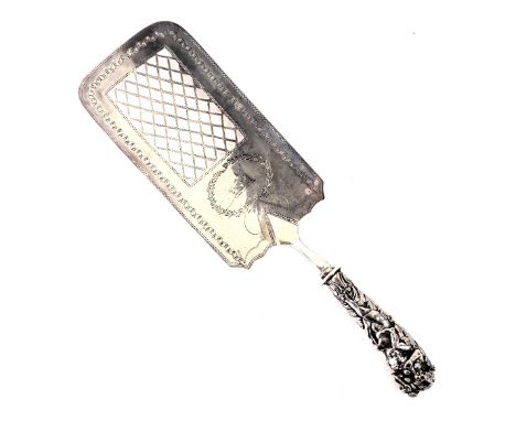 A George III silver cake or fish slice, with a cherub and vine moulded handle, on rectangular pierced plate with engine engra