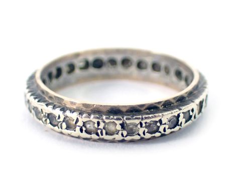 A 9ct gold and silver eternity ring, set with tiny diamonds on bicolour design, ring size K½, 2.2g all in. 