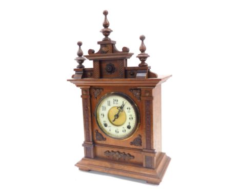 A late 19thC German walnut cased mantel clock, circular brass dial with enamel chapter ring bearing Arabic numerals, eight da