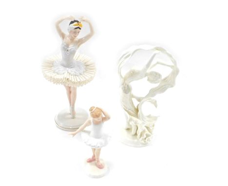 Three ceramic figures, comprising a Royal Doulton Little Ballerina, 16cm high, a Franklin Mint Swan Lake figure, 29cm high, a