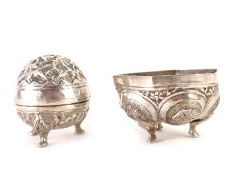 Two items of Burmese white metal, comprising a swatch pepper pot on tripod claw feet, 4cm high, unmarked, and an eastern hexa