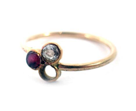 A multistone dress ring, the central section set design of three stones, two present to include diamond and ruby, on a yellow