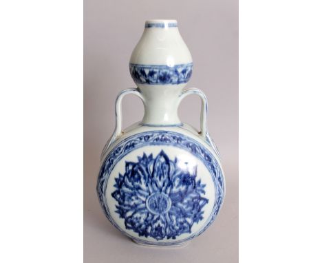 A CHINESE YONGLE STYLE BLUE & WHITE PORCELAIN MOON FLASK, with gourd neck, decorated with formal lotus roundel panels between