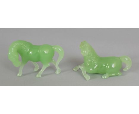 A PAIR OF 20TH CENTURY CHINESE JADE-LIKE GLASS MODELS OF HORSES, the glass of an apple-green hue, the longest 3.5in long.