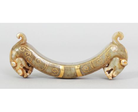 A CHINESE HAN STYLE GILT INLAID JADE CARVING, possibly a brush rest, with dragon head supports, 3.9in wide & 1.5in high.