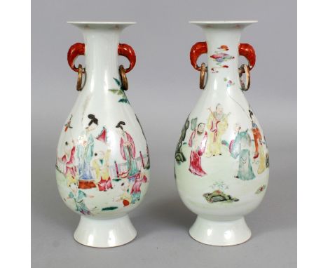 A PAIR OF LATE 19TH CENTURY CHINESE FAMILLE ROSE PORCELAIN VASES, with loose ring handles, one vase painted with ladies and c