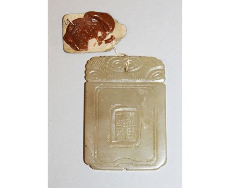 A 19TH/20TH CENTURY CHINESE RECTANGULAR JADE PENDANT, with attached export seal, 2.2in x 1.5in.