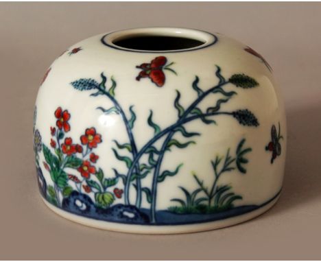 A CHINESE DOUCAI PORCELAIN BEEHIVE BRUSHWASHER, decorated with butterflies, flowers and rockwork, the base with a Qianlong se