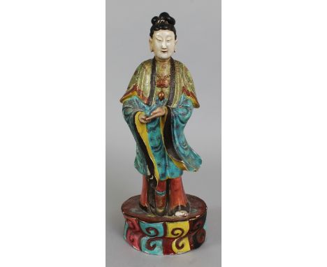 A 19TH CENTURY CHINESE FAMILLE ROSE PORCELAIN FIGURE OF A FEMALE IMMORTAL, standing in elaborately decorated robes on a mould