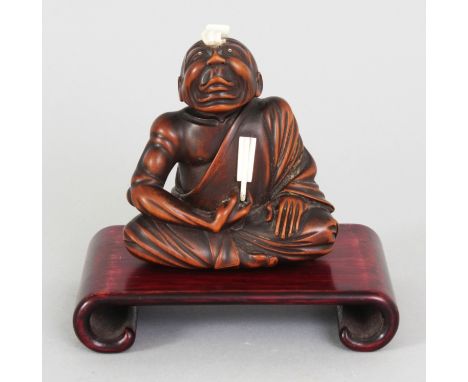 AN EARLY 20TH CENTURY SIGNED JAPANESE IVORY & HARDWOOD NETSUKE OF A SEATED SENNIN, of larger than average size, together with