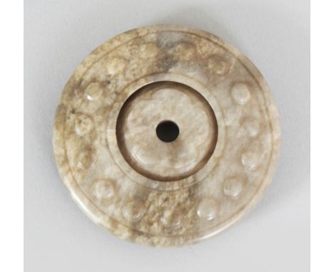 A CHINESE JADE BI DISC, together with a silk covered box, the disc of archaic design and with a moveable central section, the