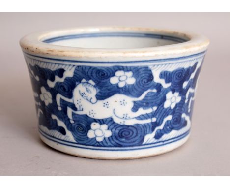 A CHINESE KANGXI STYLE BLUE & WHITE PORCELAIN BRUSHPOT, the flaring sides decorated with gambolling horses against a whorl gr