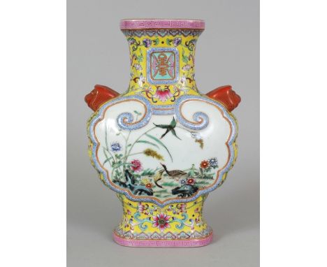 A GOOD QUALITY CHINESE FAMILLE ROSE MOULDED PORCELAIN VASE, the sides decorated with ruyi form panels of birds and foliage, t