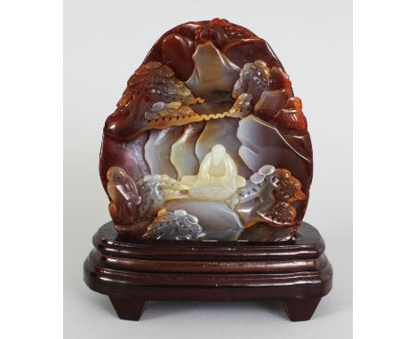 A CHINESE CARVED AGATE BOULDER, together with a fitted wood stand, one side of the stone carved with a scene of a sage seated