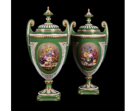 Two similar Royal Worcester green-ground and gilt urns and cover signed by W.A.Hawkins, 1907, painted with still life panels 