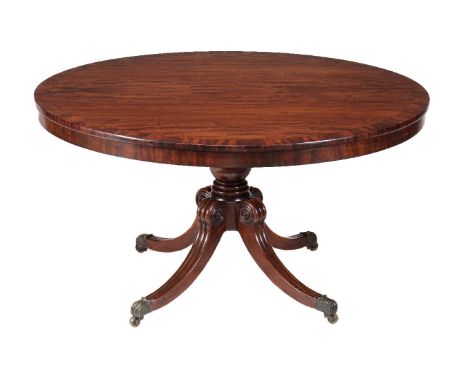 A late Regency mahogany circular centre table, circa 1820, the crossbanded and bookmatched top with plain apron above a bulbo