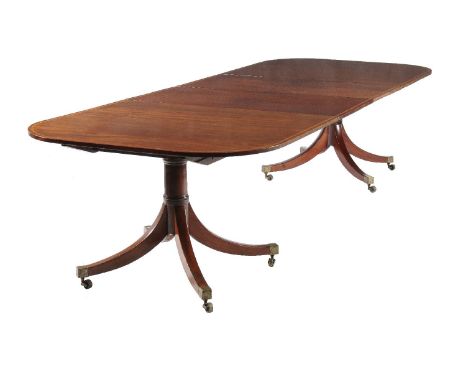 A mahogany and satinwood banded twin pillar dining table, circa 1800 and later, with two additional leaf insertions on cylind