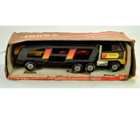 Tonka No. 1934 Car Transporter and Car Load Set. Appears very good to excellent in fair to good box. Note: We are always happ