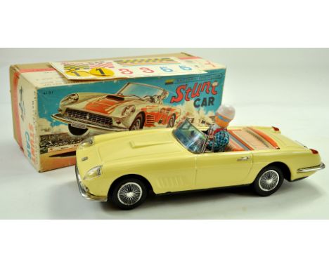 Bandi Battery Operated Tinplate Stunt Car. Toy is of Ferrai with Driver Figure in Lemon Yellow. Superb piece appears very goo