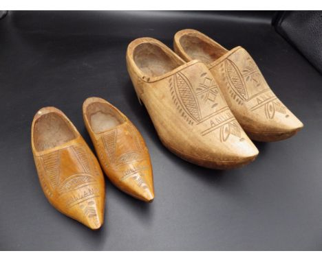 Two pairs of vintage wooden hand carved Dutch clogs.