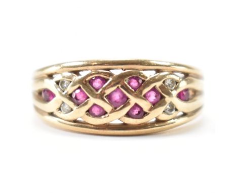A vintage 9ct gold, ruby &amp; diamond ring. The ring having round brilliant cut rubies set to a knotted pattern &amp; flanke