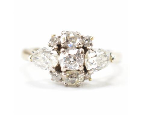 A French 18ct gold and diamond cluster ring. The ring set with two old pear cut and three old oval cut diamonds to plain tape