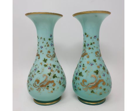 A pair of early 20th century green glass vases, highlighted in gilt, 24 cm high, three cups and saucers and a mug (9)The roun